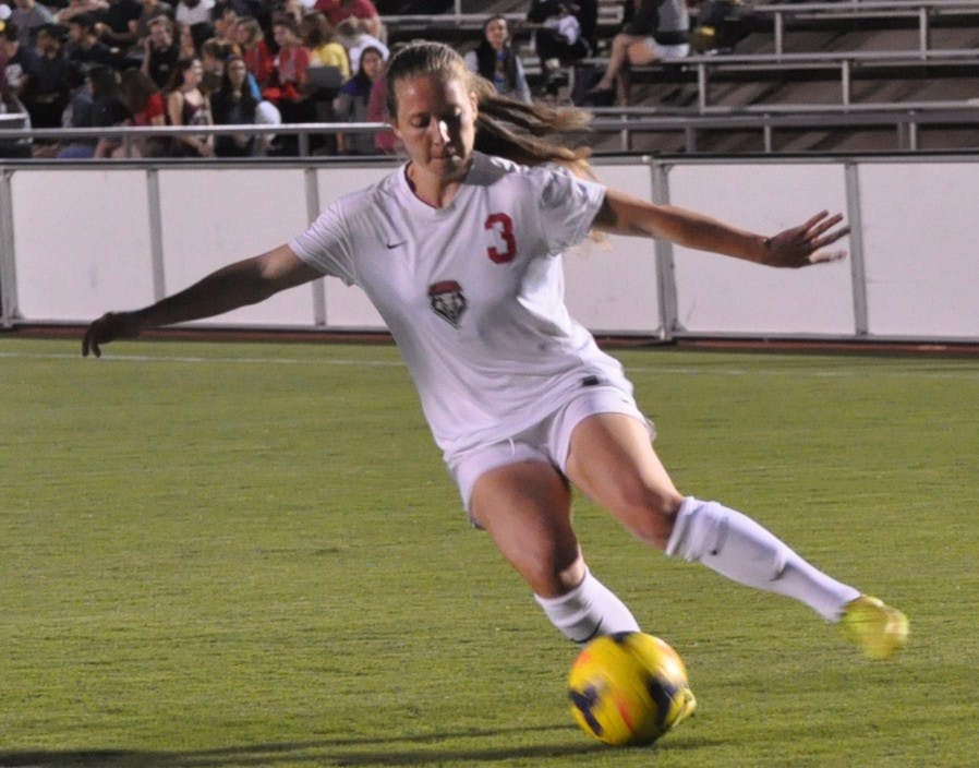 New Mexico's Dylann O'Connor dumps the ball in to the Nevada defensive end against Nevada Friday night at the UNM Soccer Complex. UNM improved to 3-0 in Mountain West play following a 1-0 win over the Wolfpack.