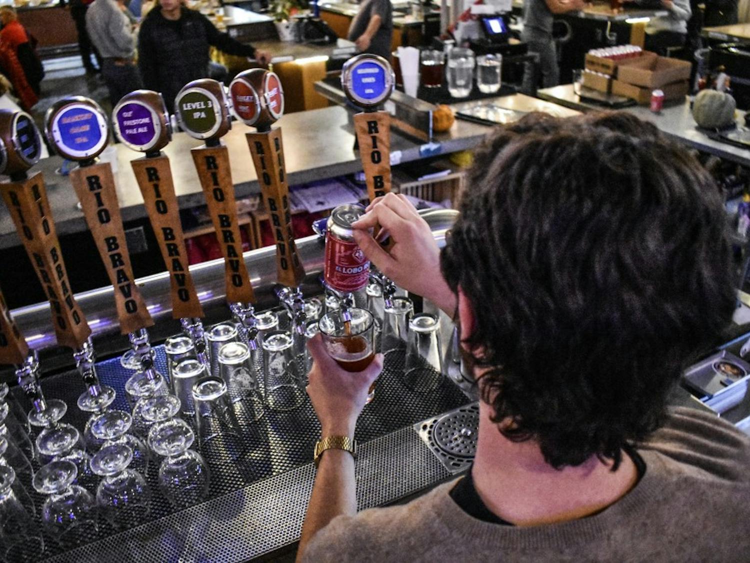 A bartender at the Rio Bravo Brewing Company pours a new beer, the Lobo Rojo.