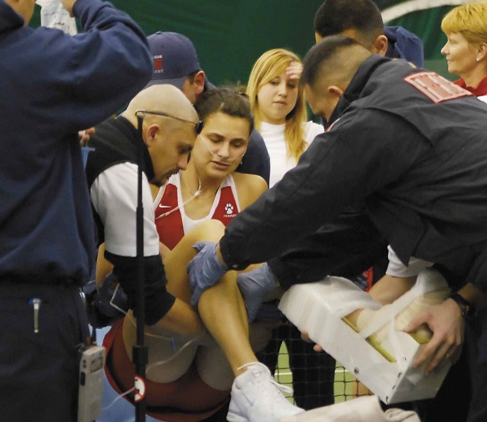 Tennis player Iva Gersic is placed on a stretcher after tearing ligaments in her left ankle during a doubles match against Boise State on Friday at the UNM Tennis Complex.  