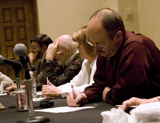 Bradley Clawson takes notes during a meeting about worker safety at the Doubletree Hotel on Wednesday.