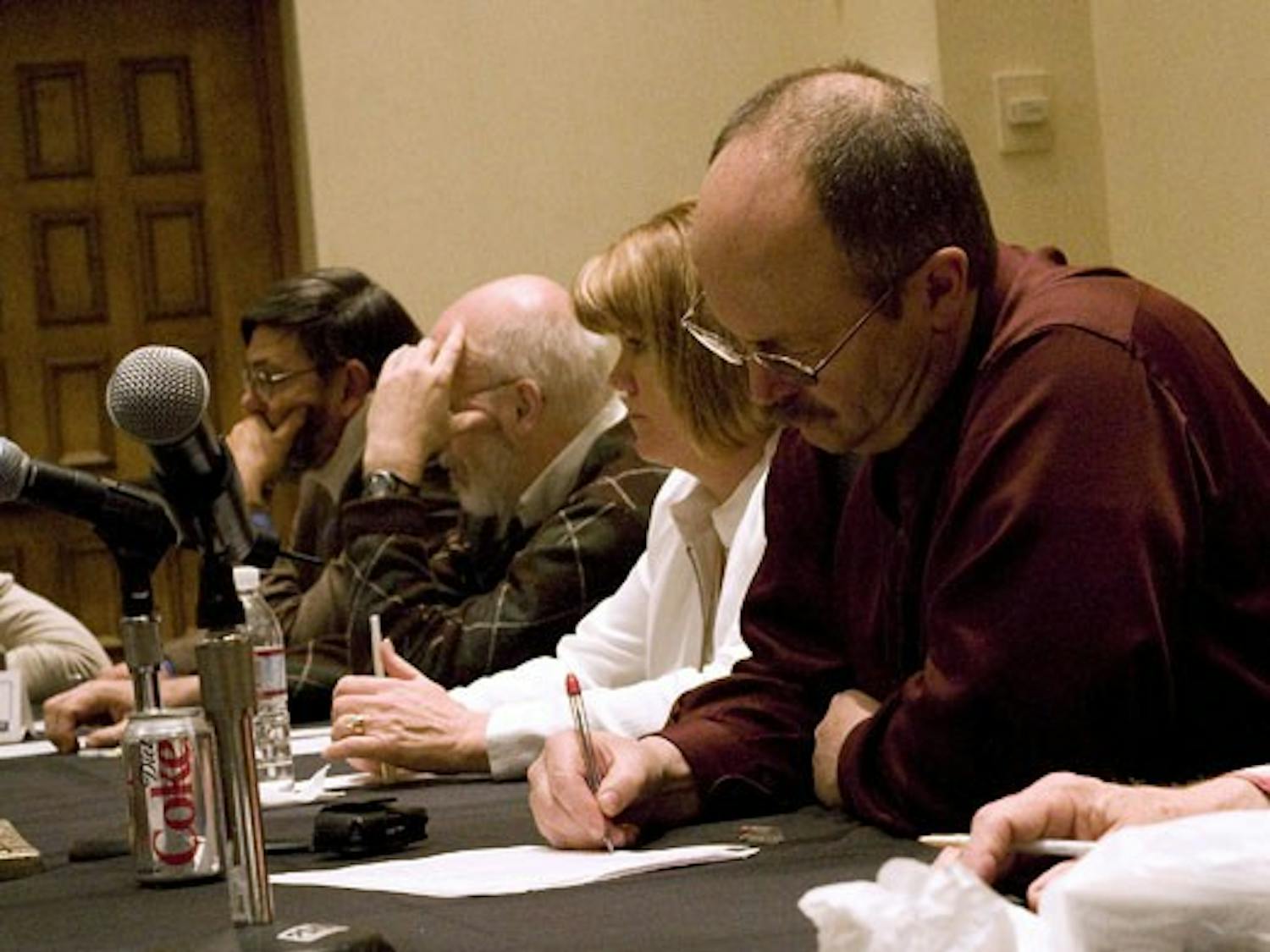 Bradley Clawson takes notes during a meeting about worker safety at the Doubletree Hotel on Wednesday.