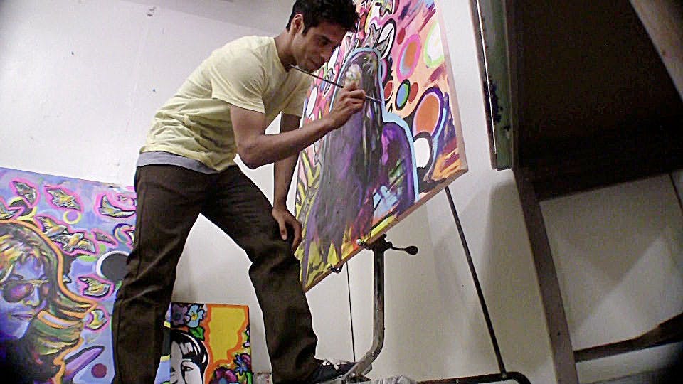 	Allen Colmenares, an art undergraduate, works on a painting of his mother at the Art Building.