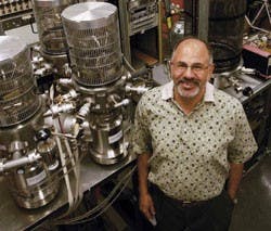 UNM professor Mohamed El-Genk stands in front of lab equipment that simulates the conditions of space for computer chip testing Tuesday in the Farris Engineering Center.  
