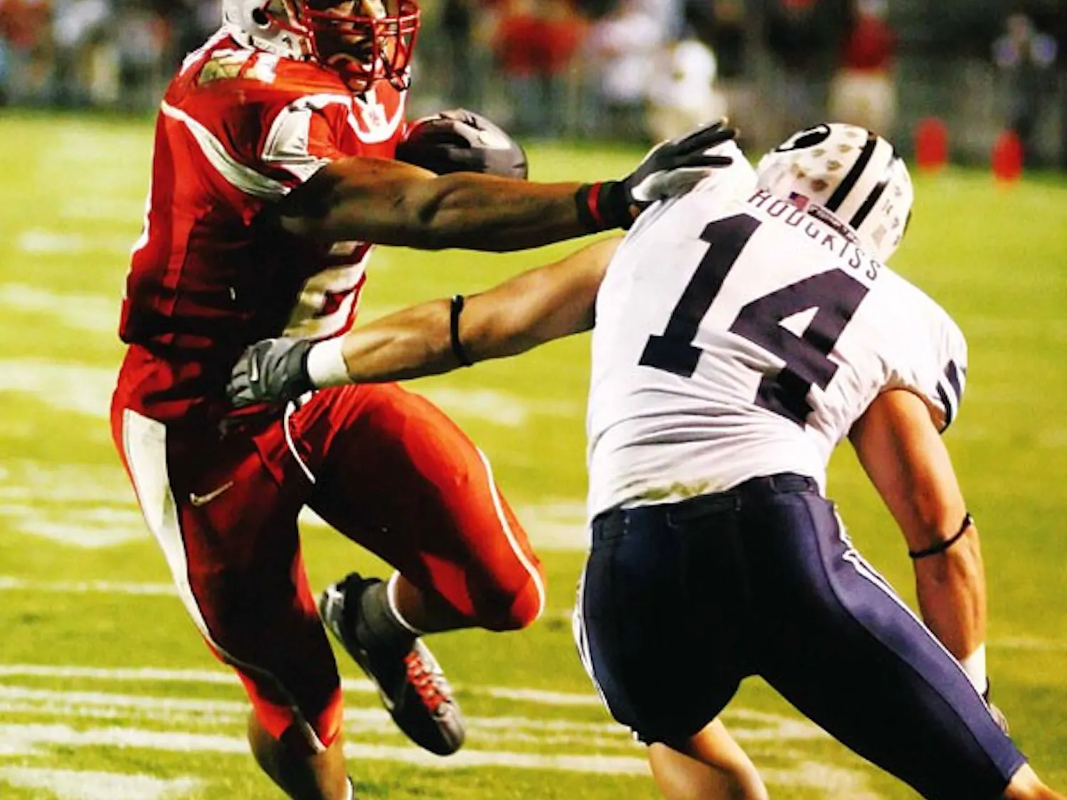 UNM's Rodney Ferguson runs past BYU's Corby Hodgkiss before scoring in the third quarter at University Stadium on Saturday.