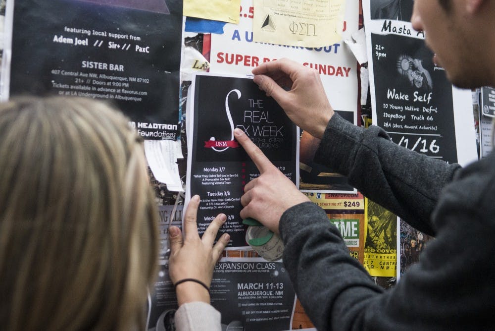Students for Life President Sadé Patterson and Vice President Matt Drum hang posters promoting their organization’s week-long “Real Sex Week” event on Sunday afternoon. Patterson said she has spent the last several weeks pitching the event to student groups on campus, explaining how Students for Life is aiming for a different type of discussion than the more controversial Sex Weeks of recent years.