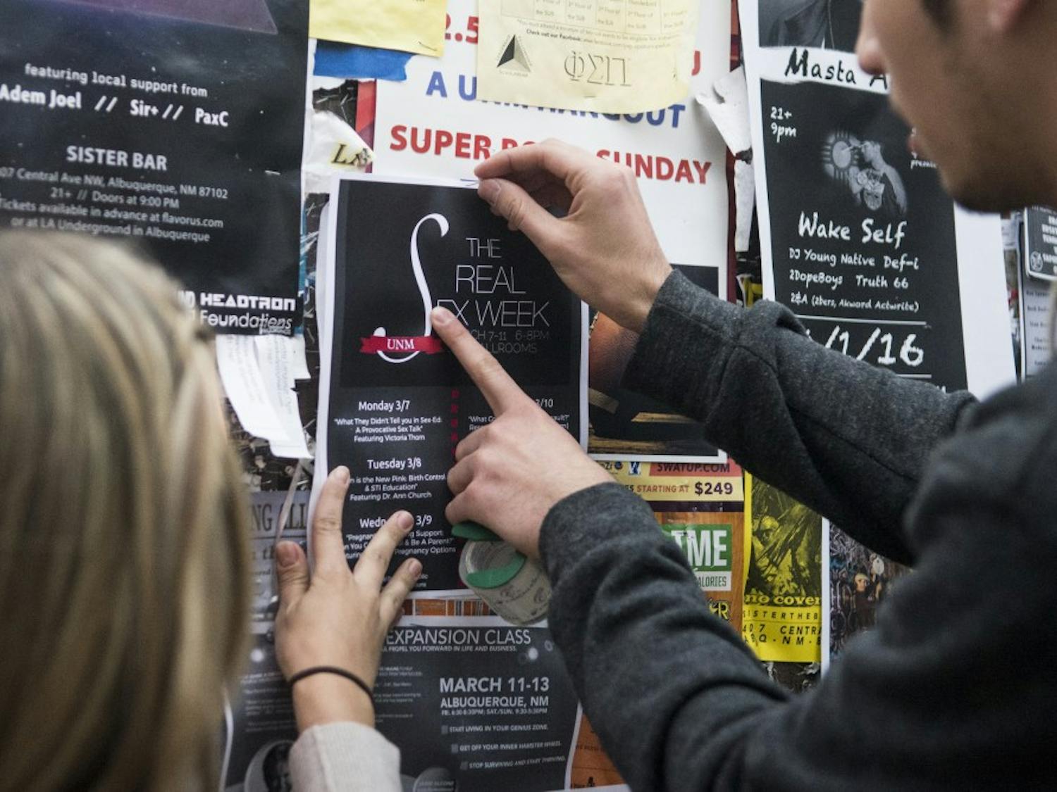 Students for Life President Sadé Patterson and Vice President Matt Drum hang posters promoting their organization’s week-long “Real Sex Week” event on Sunday afternoon. Patterson said she has spent the last several weeks pitching the event to student groups on campus, explaining how Students for Life is aiming for a different type of discussion than the more controversial Sex Weeks of recent years.