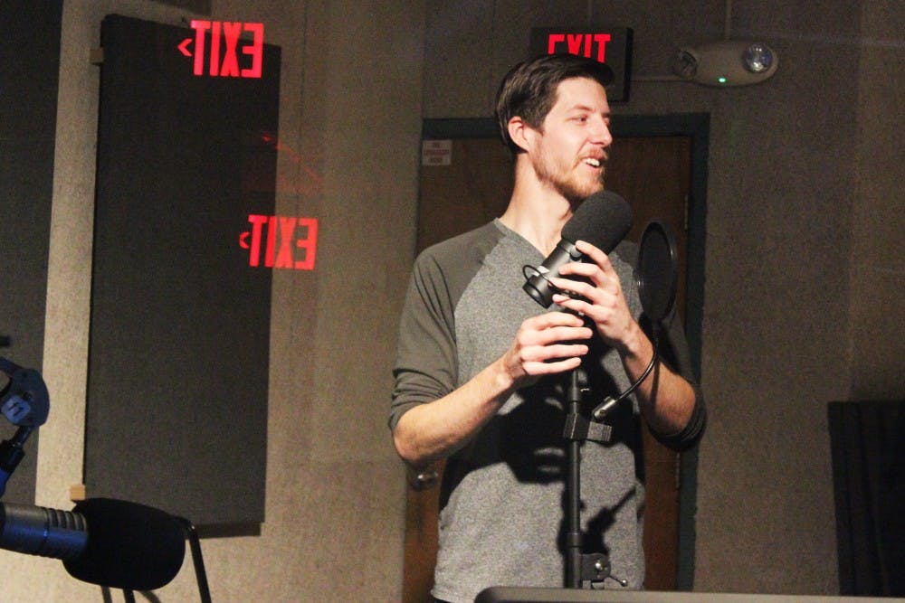 Marshall Broyles adjusts a microphone in the studio at KUNM during a voice tracking session Saturday afternoon. Broyles has been with KUNM for four years.