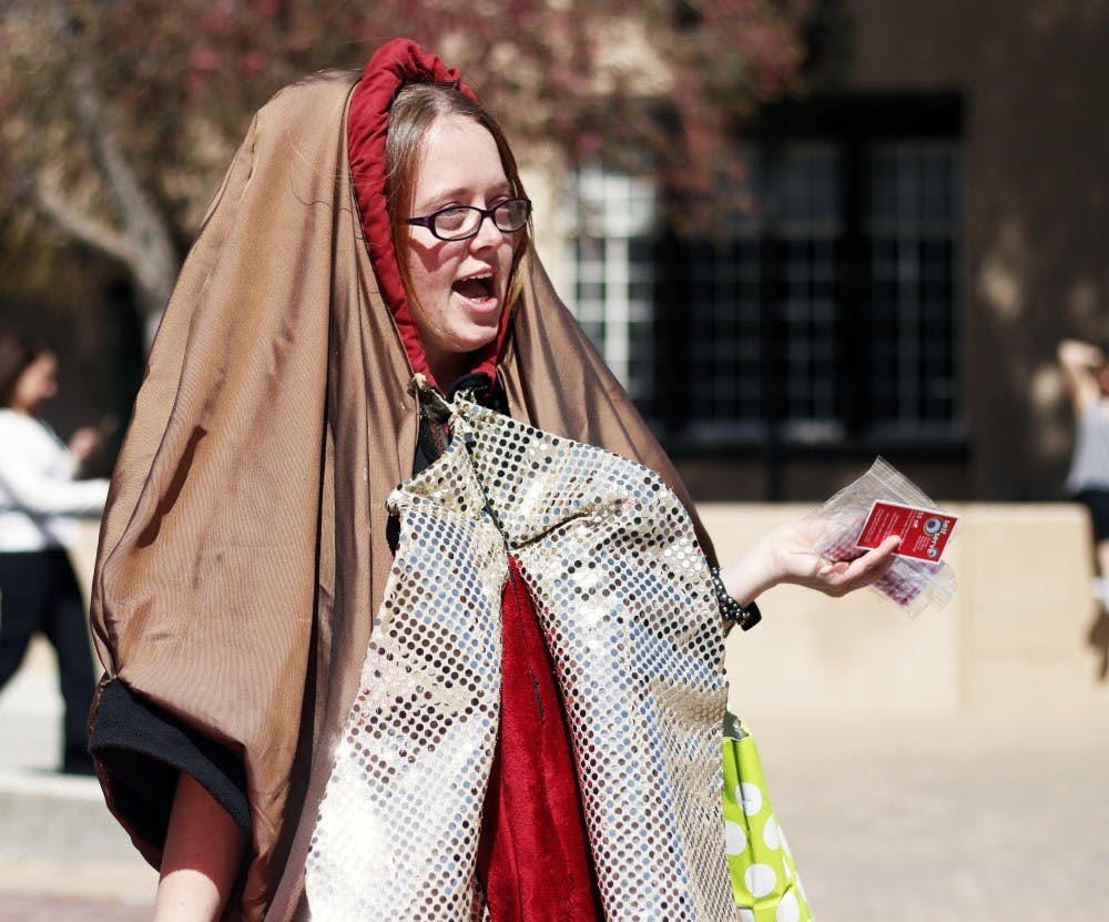 Hunter Riley, manager of Self Serve Sexuality Resource Center, stands Wednesday March 9, 2016  at Smith Plaza. The costume Riley is one of two vulva costumes that belongs to Self Serve, in which the other costume has gone missing.