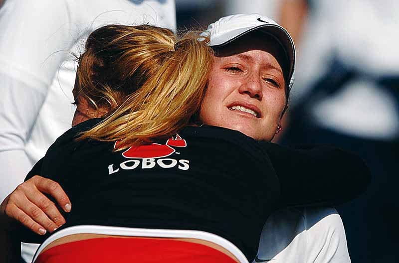 Jennifer Ryba hugs senior Nora Quintal after the Lobos' 4-1 loss to Brigham Young in Colorado Springs, Colo., during the Mountain West Conference Championship on Friday. 