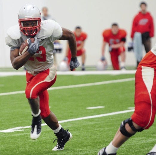 Running back Terence Brown darts toward the outside during the Lobos' scrimmage Saturday. Brown, who had 82 yards on the ground, was outrushed only by A.J. Butler, who ran for 96 yards.