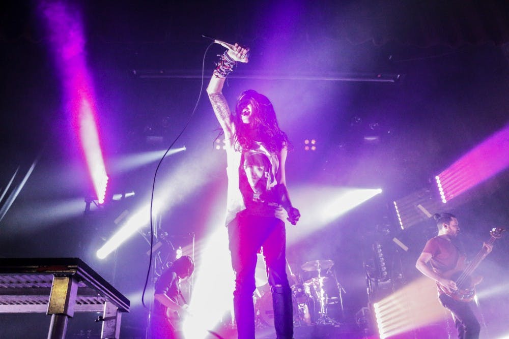 Lead singer of Mayday Parade, Derek Sanders, raises his mic in the air while performing Friday night at Sunshine Theater. Mayday Parade headlines the show with opening acts by The Maine and The Technicolors.