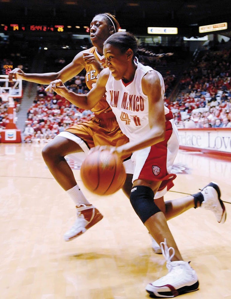 UNM guard Brandi Kimble drives toward the basket as Longhorns' Niqky Hughes defends during the Lobos' 63-60 win at The Pit on Friday.