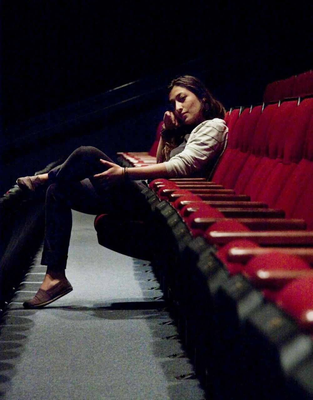 	Megan Branch, a theater major, sits in the shadows of Theatre X in Popejoy Hall on
Monday. Branch will attend The New School in New York City in August to start her
graduate degree in drama.