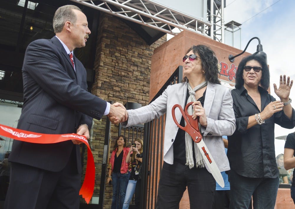 Mayor Richard Berry, left, shakes hands with KISS guitarist/vocalist Paul Stanley, center, after Stanley cuts the ribbon for the grand opening of Rock &amp; Brews, along with KISS bassist/vocalist Gene Simmons, far right, on Tuesday morning. Rock &amp; Brews is a rock ‘n’ roll-themed family restaurant co-owned by Stanley and Simmons, along with Michael Zislis and brothers Dave and Dell Furano.