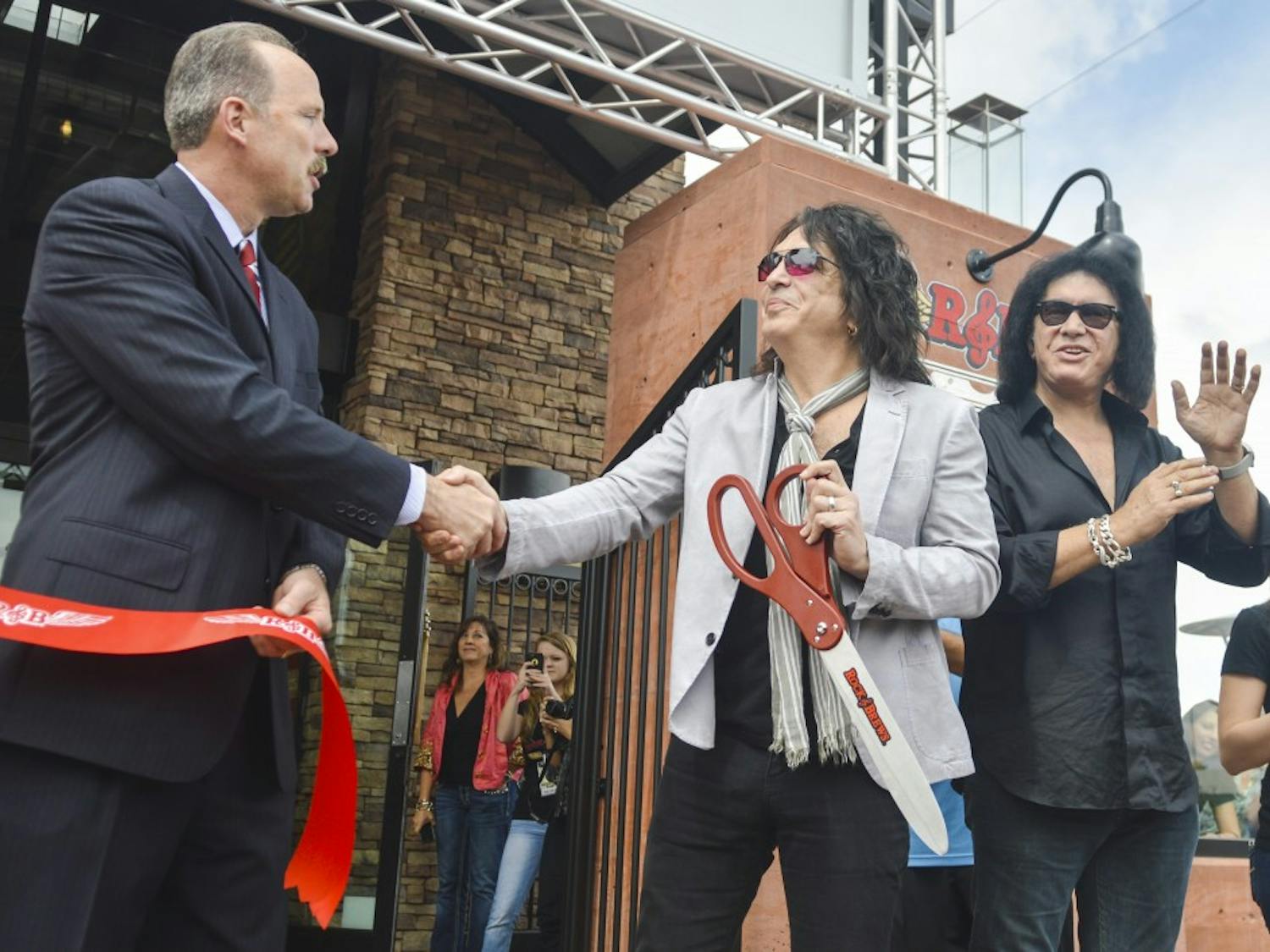 Mayor Richard Berry, left, shakes hands with KISS guitarist/vocalist Paul Stanley, center, after Stanley cuts the ribbon for the grand opening of Rock &amp; Brews, along with KISS bassist/vocalist Gene Simmons, far right, on Tuesday morning. Rock &amp; Brews is a rock ‘n’ roll-themed family restaurant co-owned by Stanley and Simmons, along with Michael Zislis and brothers Dave and Dell Furano.
