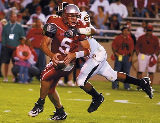 Lobo quarterback Chris Nelson gets sacked by Missouri defensive end Brian Smith during the Lobos' 27-17 loss at University Stadium on Saturday. Nelson was sacked eight times during the game. 