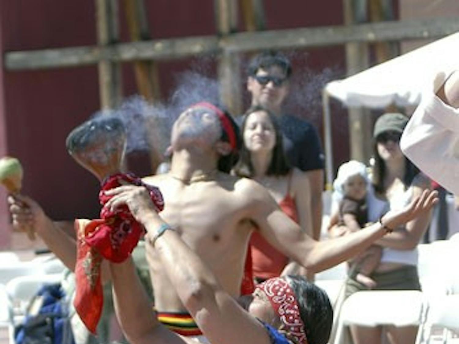 Andrea Lopez and student Travis McKenzie perform an Aztec ceremony to honor civil rights leader Cesar Chavez at the National Hispanic Cultural Center on Saturday.