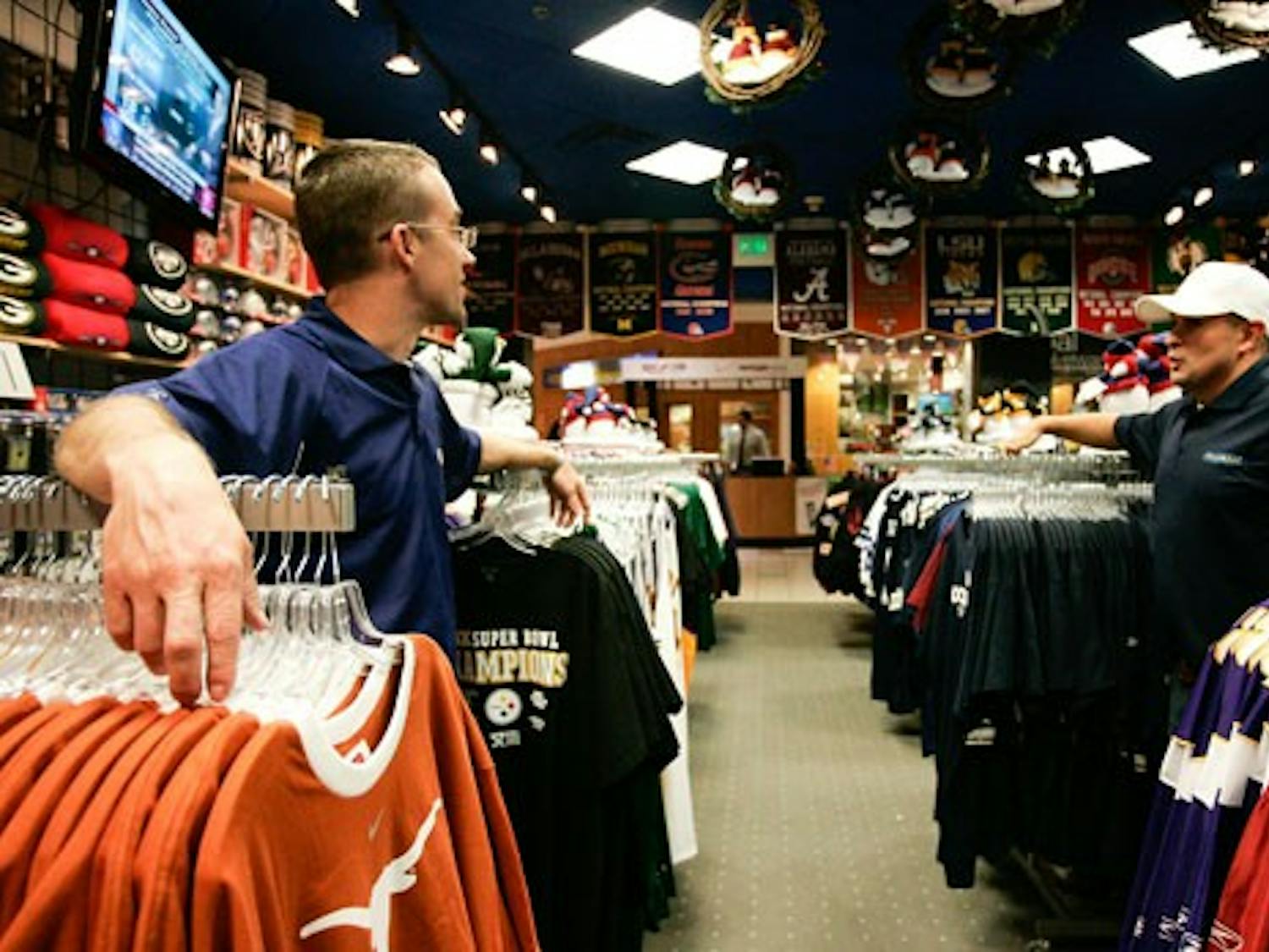 Pro Image co-owners Chris Byrd, left, and Steve Horton talk Tuesday at their store in Cottonwood Mall.