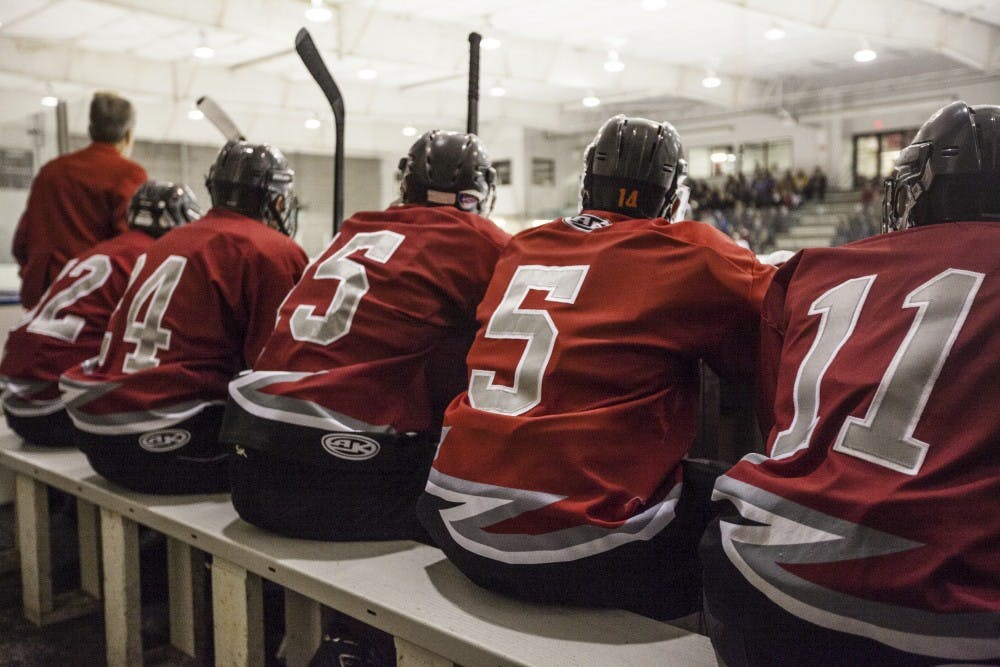 UNM hockey players sit on their bench during a game on Sept. 27, 2013 at the Outpost Arena.