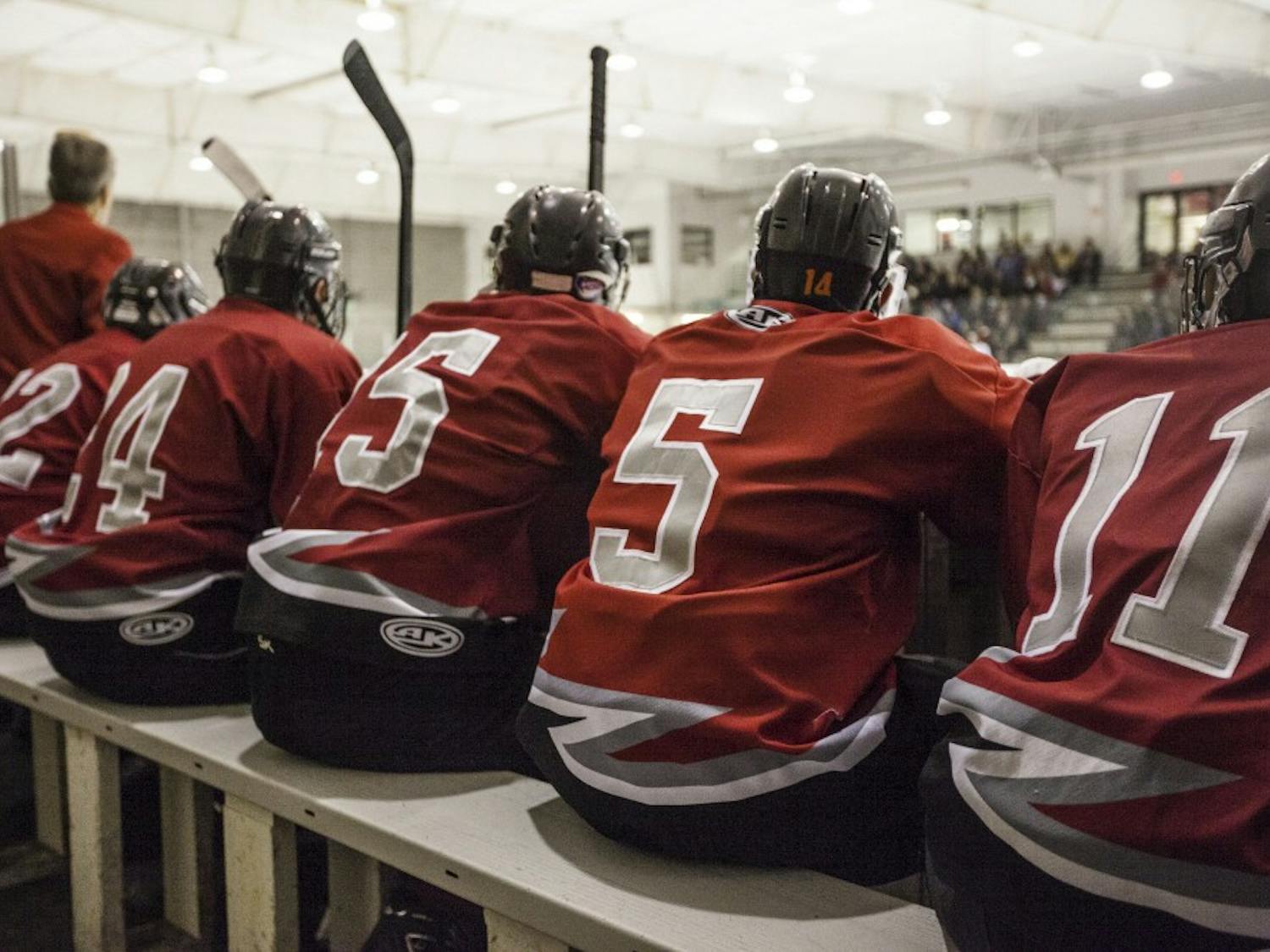 UNM hockey players sit on their bench during a game on Sept. 27, 2013 at the Outpost Arena.