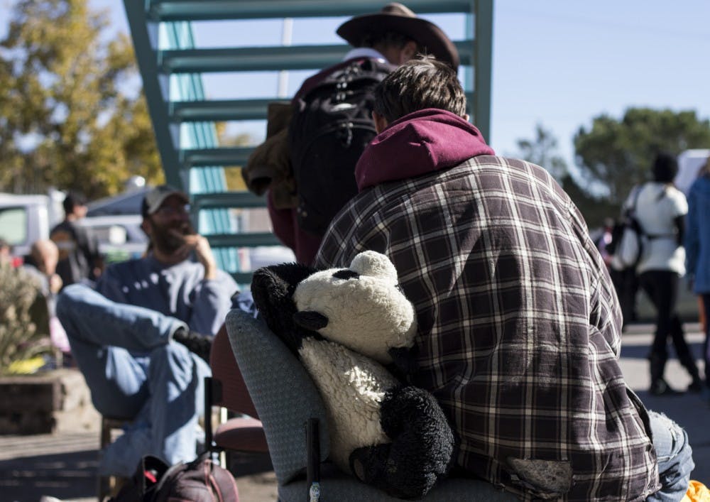 Clients sit outside St. Martin’s day shelter and soup kitchen, located in downtown Albuquerque, on Friday, November 2. St. Martin’s will see an influx of clients in the month of December.