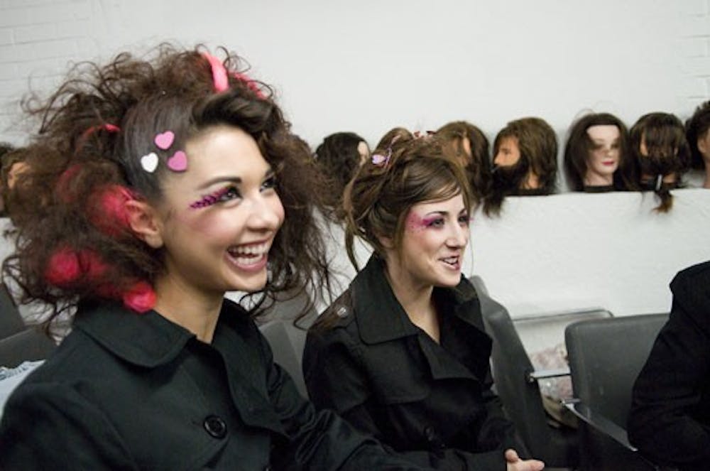 Kristy Borrego Ojinaga, left, and Marqueline Carrillo talk before taking stage at the Go Red for Women Charity Hair and Fashion Show at Urban Academy on Tuesday. All proceeds went to the American Heart Association's program to help battle heart disease.