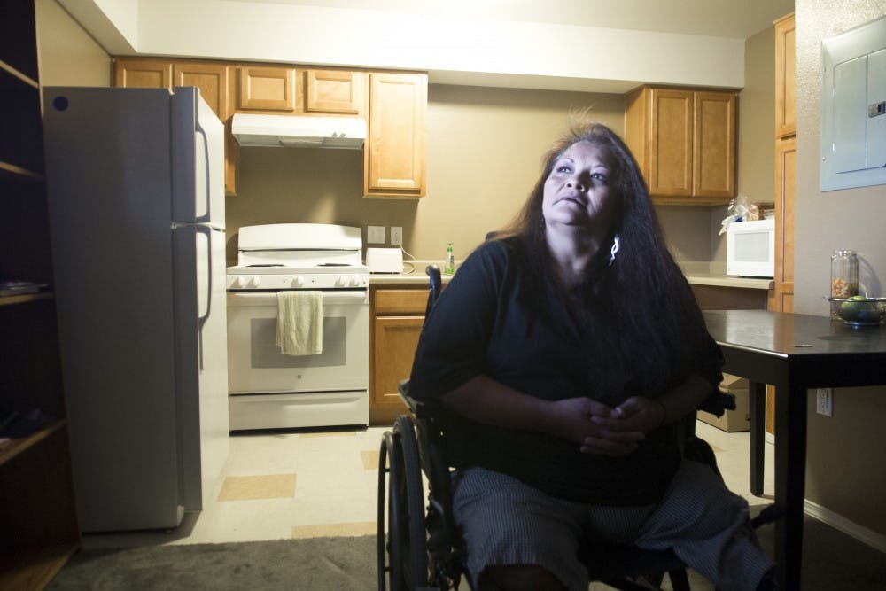 Naomi Martinez relaxes inside her home at the Sundowner apartments on Thursday. Martinez found her studio apartment through the Supportive Housing Coalition, an organization that helps find permanent housing for chronically homeless people. 