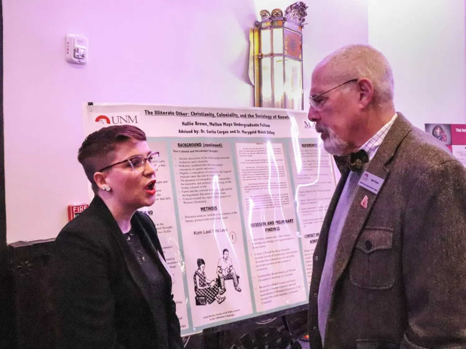Hallie Brown explains her research to an attendee of the UNM Alumni-hosted appreciation dinner for sate lawmakers on Jan. 29, 2018.
