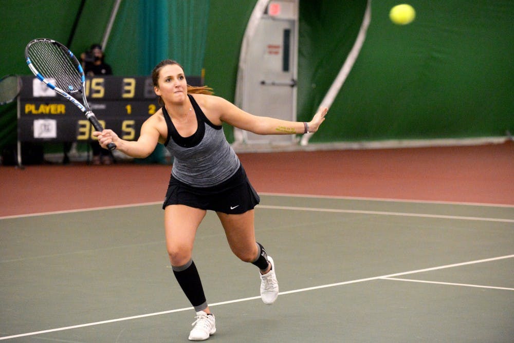 Junior Ludivine Burguiere reaches out to return the ball while playing a doubles match Saturday evening at the Linda Estes Tennis Center. The Lobos beat out Utah 5-2.