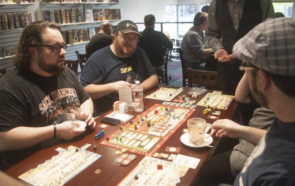 A group of local gamers, who call themselves, Game Night Every Night, play Russian Railroads at Empire Board Library on opening night. The cafe opened Friday and is the first of its kind in New Mexico. 