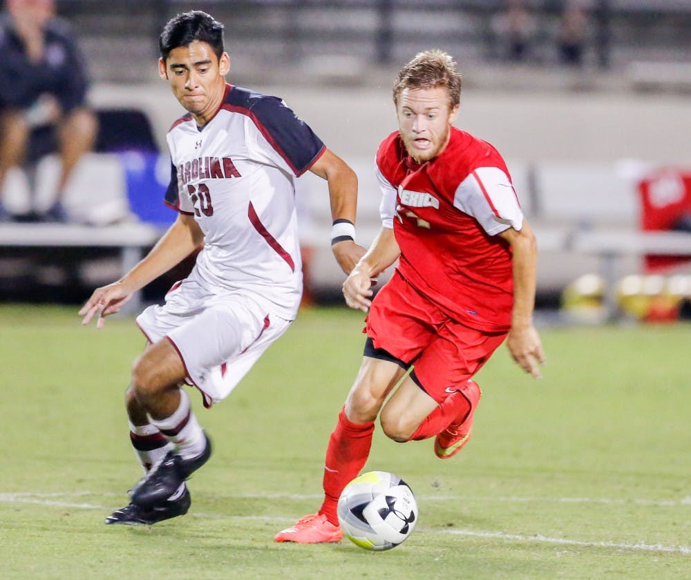 Lobos forward Chris Wehan runs past South Caroline midfielder Martin Ramos during their game Sept. 25, 2015. The Lobos lost to the Gamecocks 2-1.