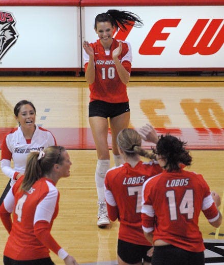 Seniors Jeanne Fairchild, center, Sarah Kwasigroch, bottom left, and Gayle Tripp, left, celebrate with their teammates during Saturday's 3-0 win over Virginia Commonwealth at Johnson Center. The Lobos finished the season 22-7 overall but were not selected