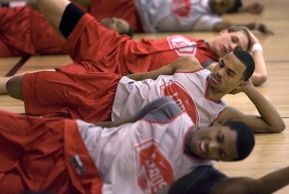 UNM guard Jamaal Smith stretches during practice Thursday. 