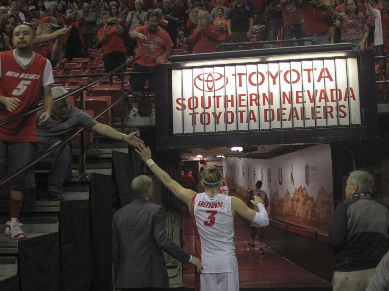 New Mexico senior guard Hugh Greenwood high-fives fans as he walks off the court for the last time Wednesday afternoon at the Thomas & Mack Center in Las Vegas. The Lobos lost to the Falcons in the Mountain West Basketball Championships for the first time since Greenwood joined the team in 2011-12.