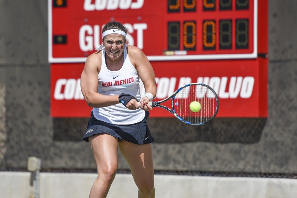 Senior Ludivine Burguiere attacks an oncoming ball during a match against New Mexico State on Saturday, March 25, 2017 at the McKinnon Family Tennis Stadium. The Lobos defeated the Aggies 5-2.