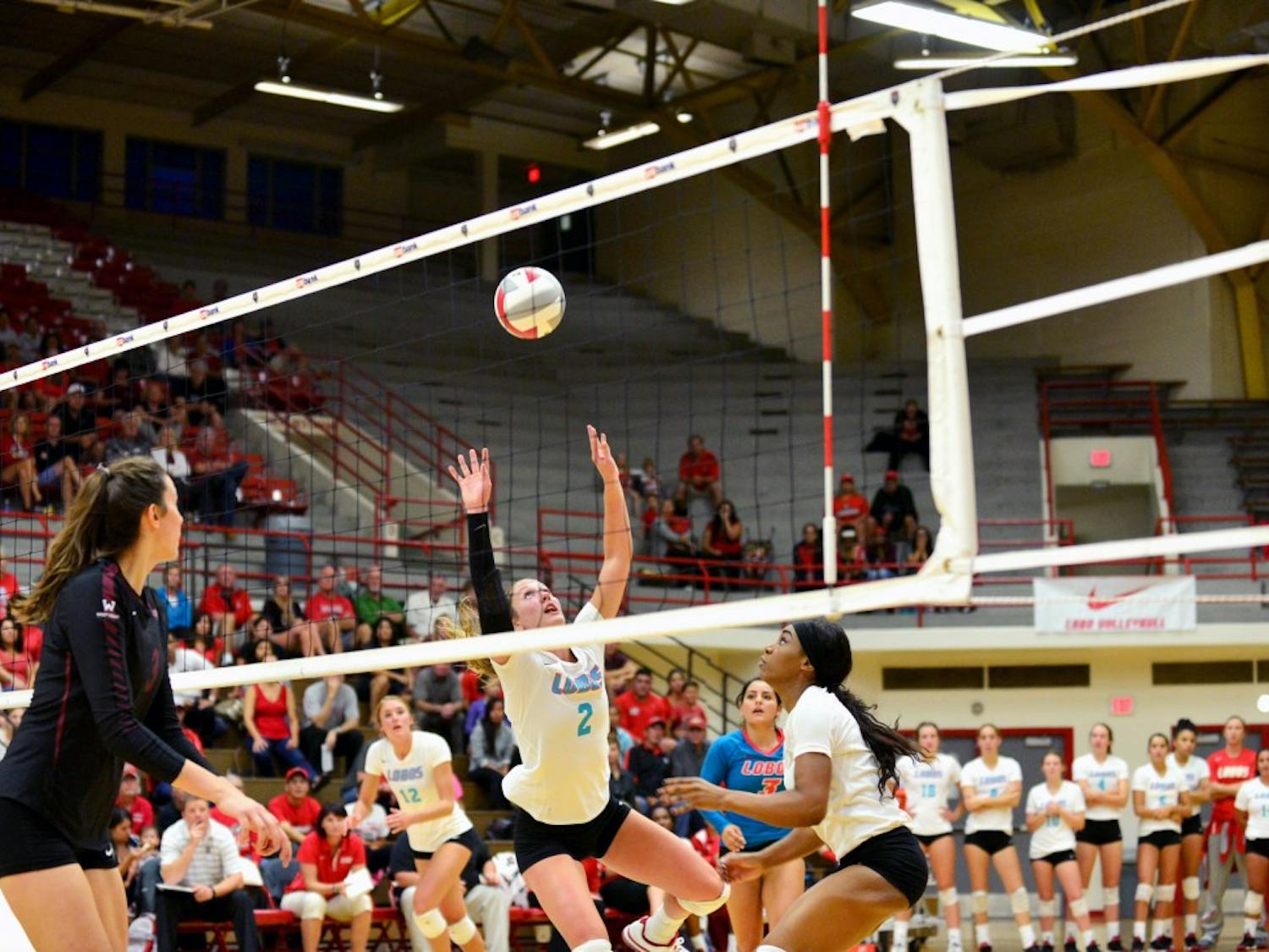 Hannah Johnson sets up Simone Henderson for a kill against Santa Clara Friday night. The first of three games in the Lobo Classic was in the Lobos favor, beating the Broncos 3-0 for head coach Jeff Nelson’s 400th win.