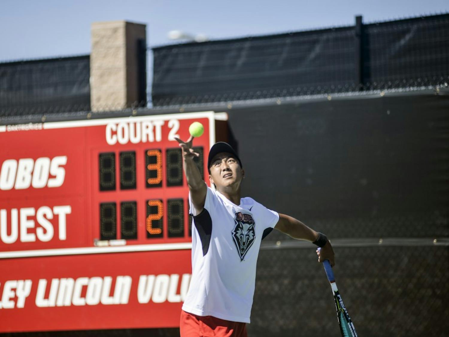 Lobos Augustus Ge sets up his serve during the Balloon Fiesta Invitational Oct. 9. The invitational was held at the McKinnon Family Tennis Center and lasted three days with singles and doubles matches.