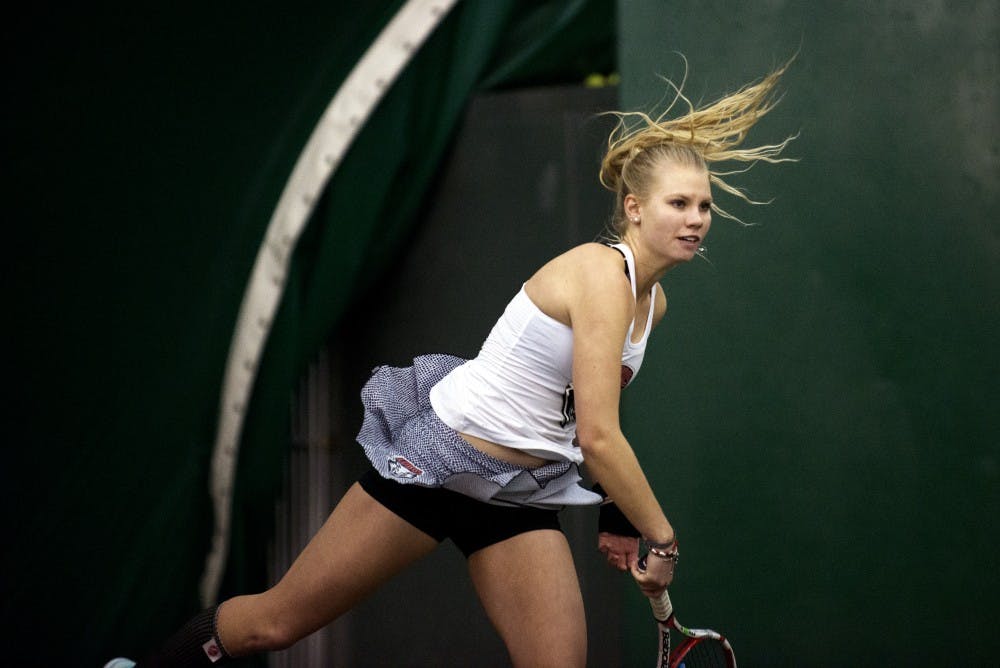 Junior Dominique Dulski returns the ball to a Colorado player during a doubles match Friday at the Linda Estes Tennis Center. The Lobos beat Colorado 5-2.