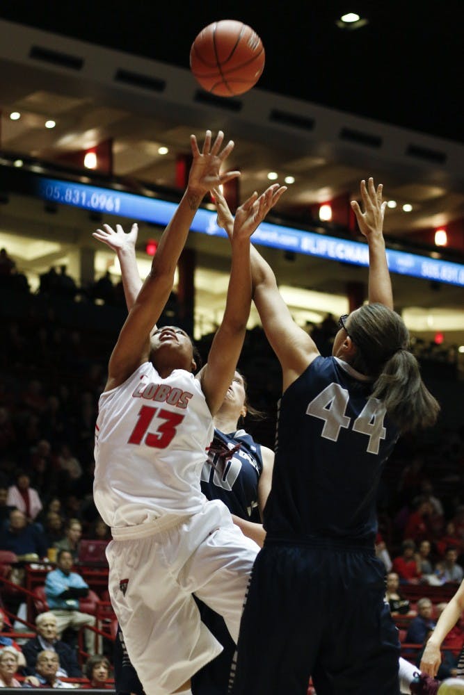 Senior forward Khadijah&nbsp;Shumpert shots for the net while being defended by Utah State players Wednesday, Feb. 10, 2016 at WisePies Arena. The Lobos will play Air Force this Saturday at 2 p.m..