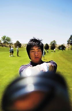 Ex-UNM golfer Jay Choi checks his club before practice at the UNM Championship Golf Course on Tuesday. 