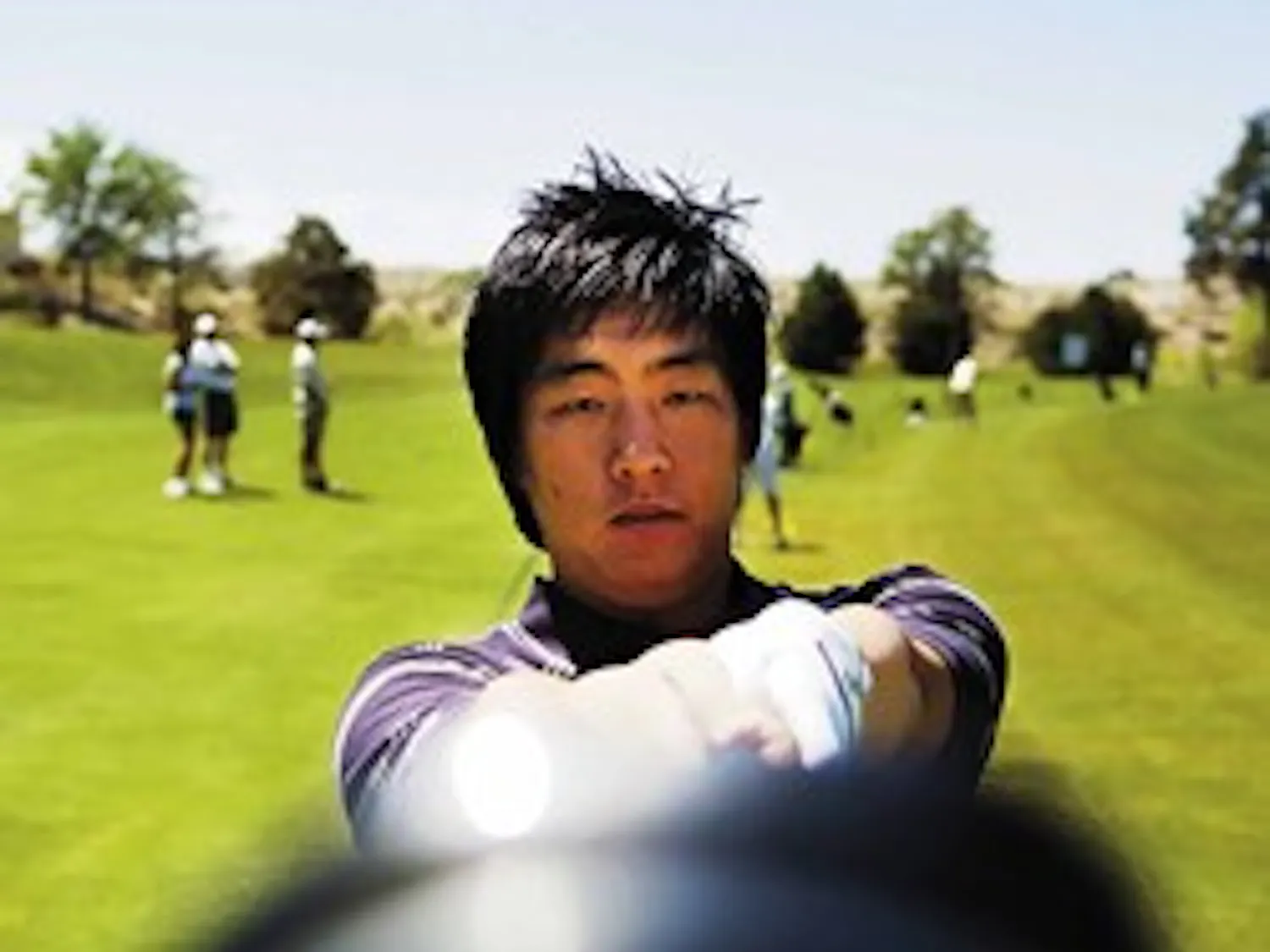 Ex-UNM golfer Jay Choi checks his club before practice at the UNM Championship Golf Course on Tuesday.