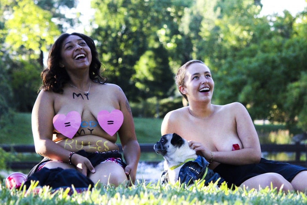 Jaycee Camrillo, left, and Lillian McDonald attend International Go Topless Day Sunday, August 28, 2016 at the UNM Duck Pond. Go Topless Day was created to spread awareness about equal gender rights.