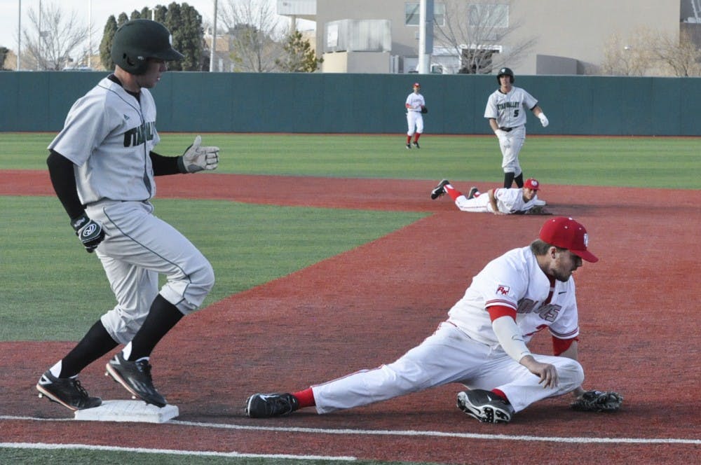 Sophomore first baseman Jack Zoellner slides to tag out Utah Valleys runner on Sunday. The Lobos won 9-3. 