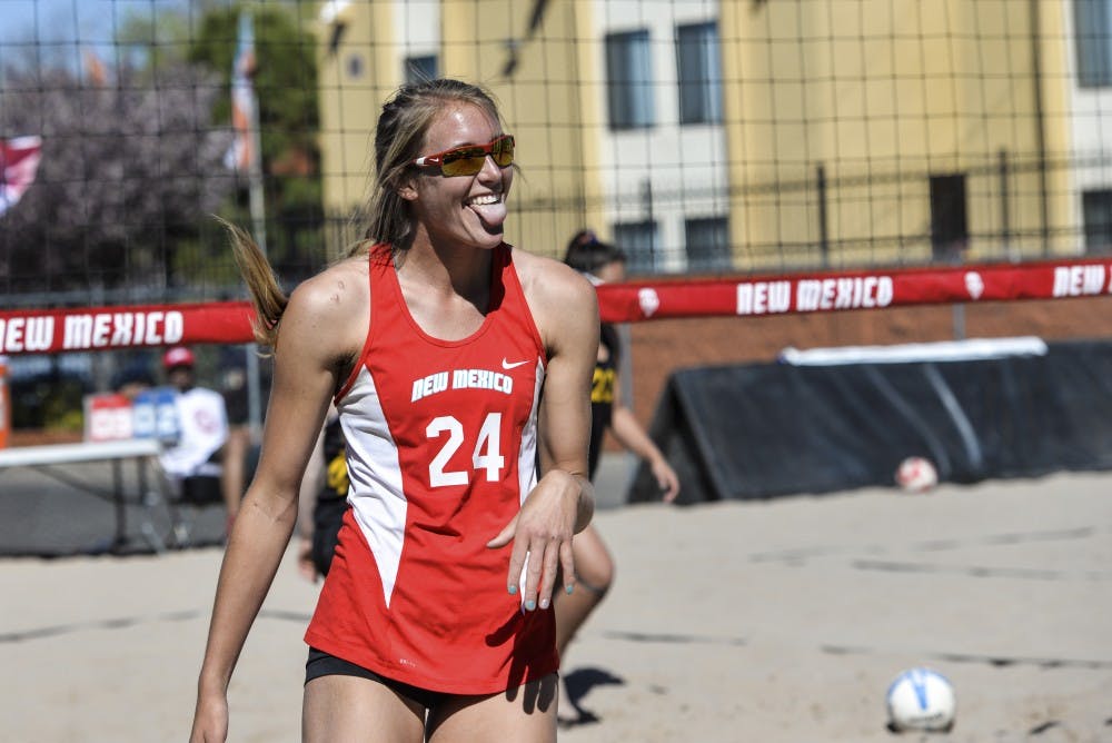 Junior Cassie House looks at her teammate and celebrates after a kill against Colorado Mesa Friday afternoon at Lucky 66 Bowl’s sand volleyball courts. The Lobos swept all four matches over the weekend.