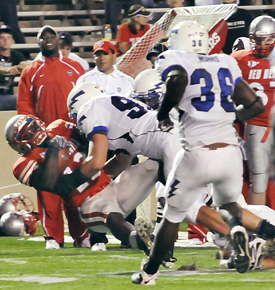 	Tailback James Wright is tackled by Air Force’s Ben Garland during Saturday’s game at University Stadium. Wright had 126 yards and two touchdowns against Air Force in the Lobo loss.