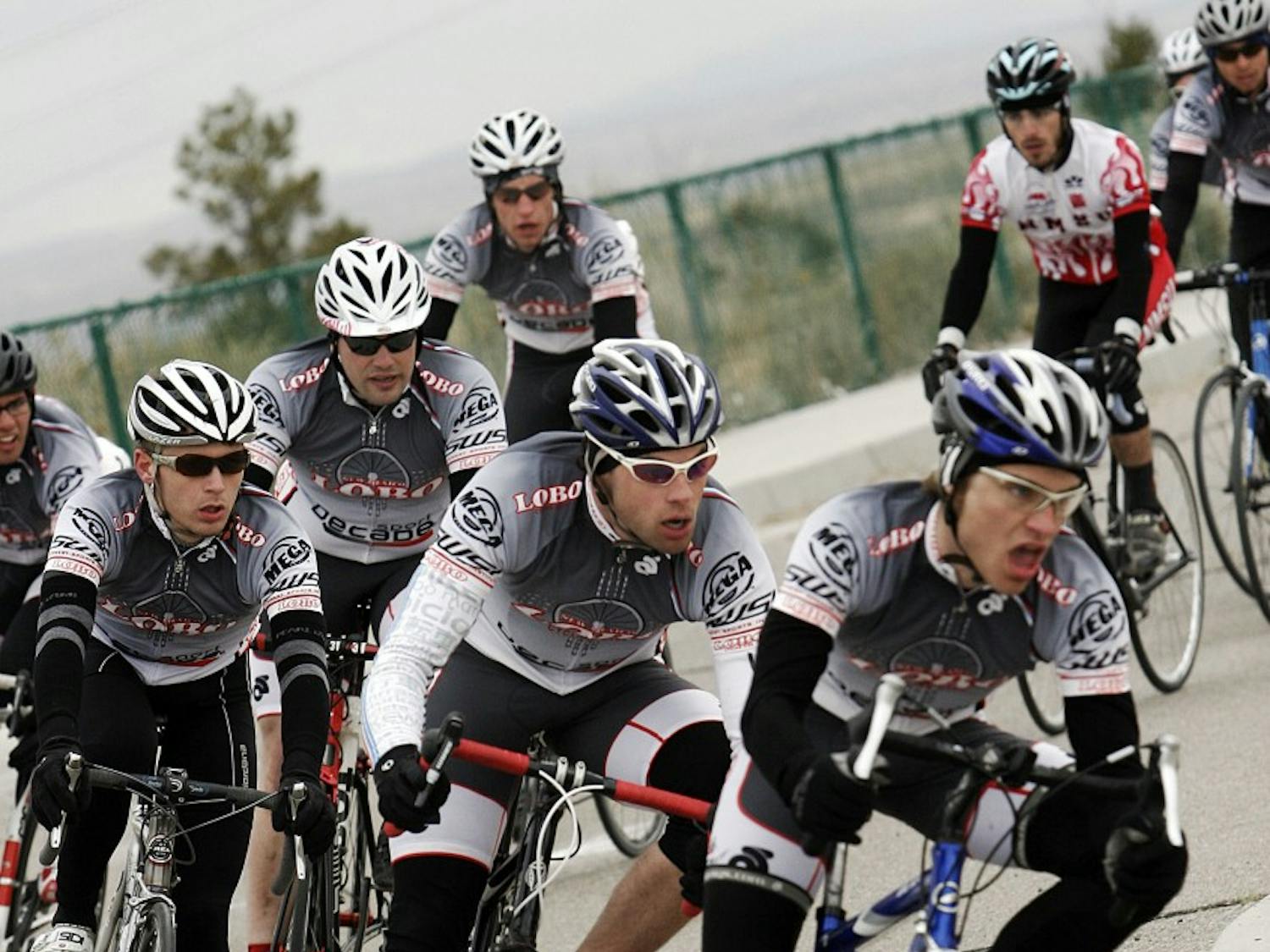 	The men’s cycling team takes a corner during their criterium event at Mesa Del Sol on Sunday. The club team is trying to increase its membership after a steep drop in membership in past years. 