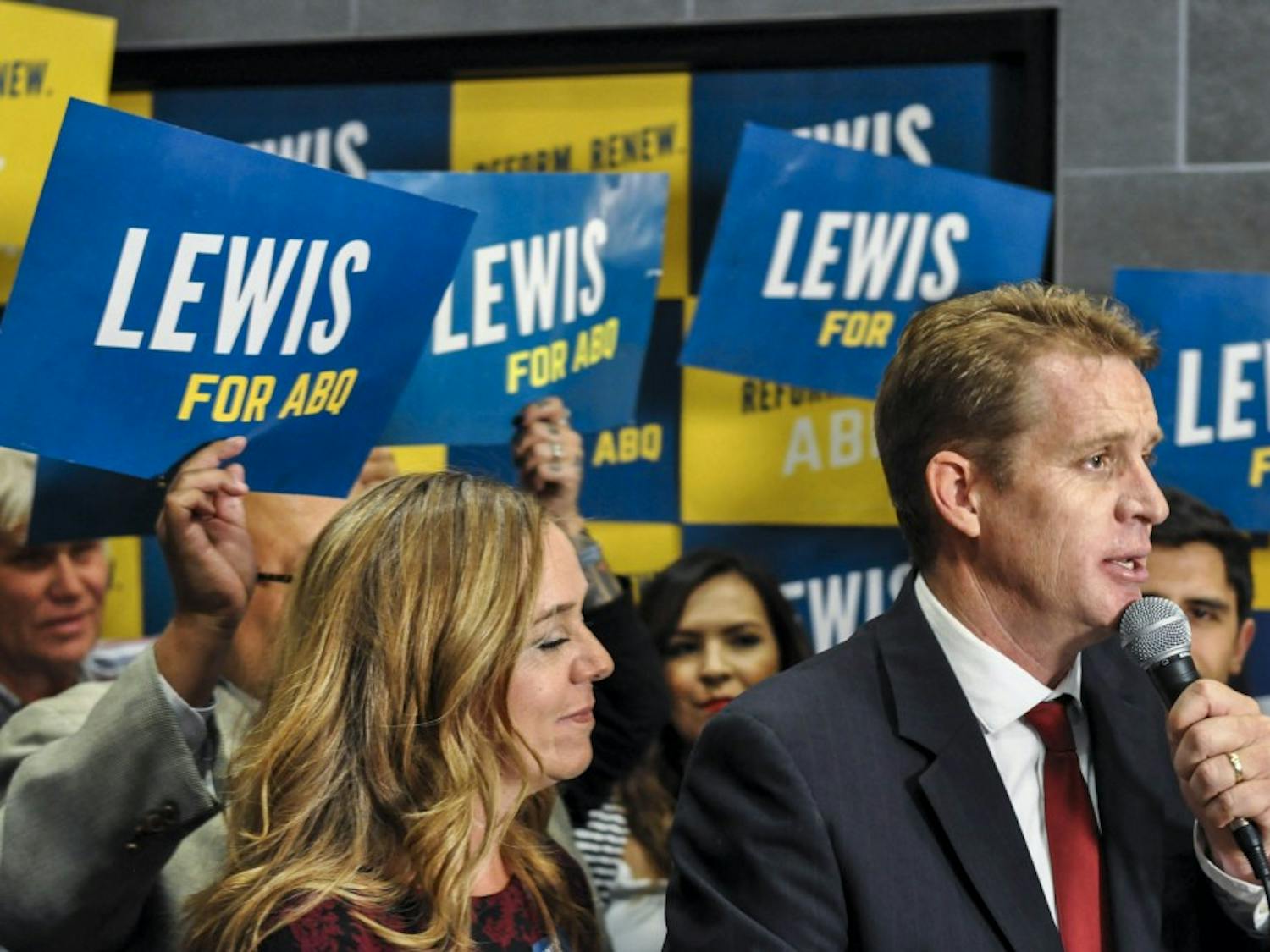 Candidate for Mayor and City Councilor Dan Lewis speaks during an election viewing event at Flix Brewhouse on October 3, 2017 as his wife Tracy Lewis (left) listens on.