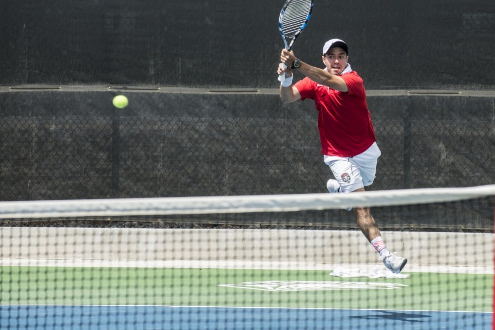 Redshirt junior Rodolfo Jauregui flies through the air after returning the ball to a Tulsa player at the McKinnon Family Tennis Stadium.