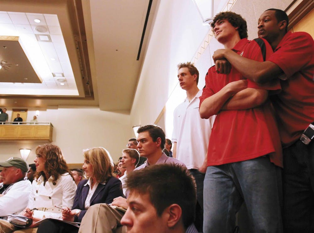 UNM basketball players, from right, J.R. Giddens, Daniel Faris and Chad Toppert listen to their new head coach, Steve Alford, during Friday's press conference in the SUB. 