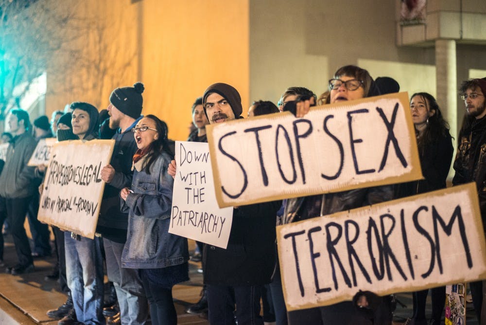 Protesters line the side walk in front of the UNM Bookstore Saturday, Feb. 6, 2016. The protest was in response to a canceled pro rape rally that was initiated by Roosh Valizadeh, one of the creators of the blog Return of the Kings. 